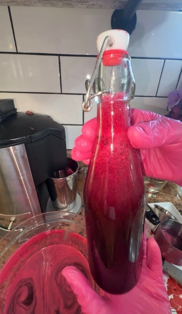 Beet watermelon juice in a glass bottle